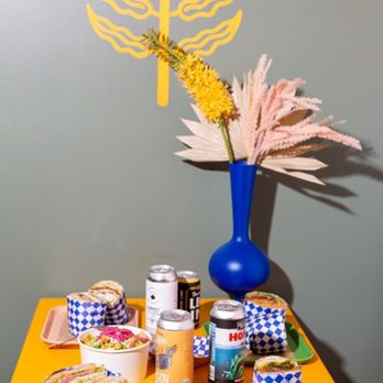 Anna's Joint - a yellow table with a blue vase and plates of food - Wine Bars Near Me - Long Beach, California Anna's Joint - a yellow table with a blue vase and plates of food - Wine Bars Near Me - Long Beach, California