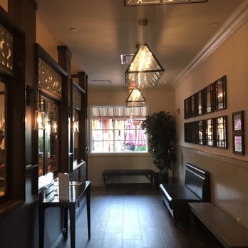Ruggeros - a long hallway with benches and a chandelier - Italian Near Me - Wading River, New York