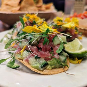 Doña - Ceviche. $13. Raw ahi tuna in a shallot-lime vinaigrette, avocado, cucumber, garlic, and micro cilantro on three mini tostadas. - Mexican Near Me - Oakland, California Doña - Ceviche. $13. Raw ahi tuna in a shallot-lime vinaigrette, avocado, cucumber, garlic, and micro cilantro on three mini tostadas. - Mexican Near Me - Oakland, California
