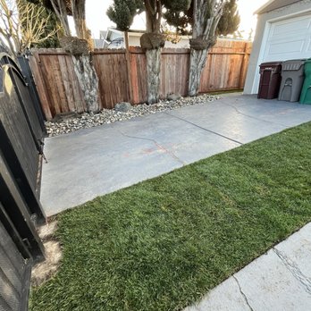 Tukia Landscaping - a yard with a fence and a trash can - Landscaping Near Me Tukia Landscaping - a yard with a fence and a trash can - Landscaping Near Me