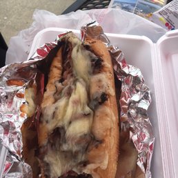 a hot dog covered in cheese and onions