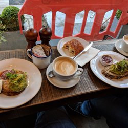 Sweet corn cakes, regular cappuccino, smashed avocado, pain au chocolat, and a chai tea latte. All excellent!