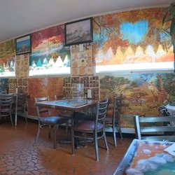 Dining room, and friend enjoying basil rolls.