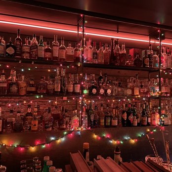 Pilcrow Cocktail Cellar - shelves of liquor bottles - Bars Near Me - Birmingham, Alabama