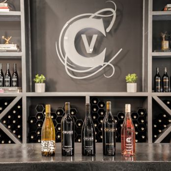 CRUSH Vineyard - bottles of wine lined up on a bar - Wine Tasting Room Near Me - Paso Robles, California CRUSH Vineyard - bottles of wine lined up on a bar - Wine Tasting Room Near Me - Paso Robles, California