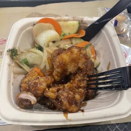 chicken and vegetables in a styrofoam container