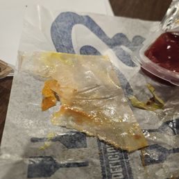 Piece of cheese/burger paper left inside my food