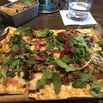 Farmer's Table - Pulled First Cut BBQ Brisket Flatbread  On it: Pepperonata, Cheddar Cheese, Pickled Red Onions, Arugula - Desserts Near Me - Boca Raton, Florida