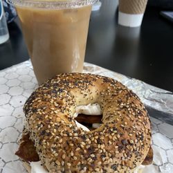 The real vegan - everything bagel with vegan cheese and tempeh bacon. Iced Oatmilk latte with caramel syrup