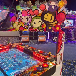 an arcade machine with a bunch of characters on it an arcade machine with a bunch of characters on it