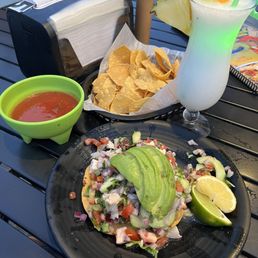 Tostada with fish, shrimp, octopus, avocado, pico de gallo, and lime and a piña colada. The seafood was very fresh.