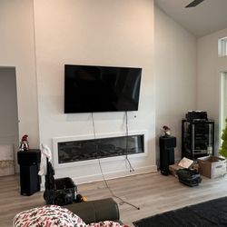Merken IT - TV Mounted above a fire place.
