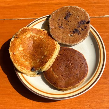 Polly's Pancake Parlor - Pancake sampler: cornmeal with blueberries (left), buckwheat with chocolate chips (top), and gingerbread with no filling (bottom). - Breakfast & Brunch Near Me - Sugar Hill, New Hampshire Polly's Pancake Parlor - Pancake sampler: cornmeal with blueberries (left), buckwheat with chocolate chips (top), and gingerbread with no filling (bottom). - Breakfast & Brunch Near Me - Sugar Hill, New Hampshire