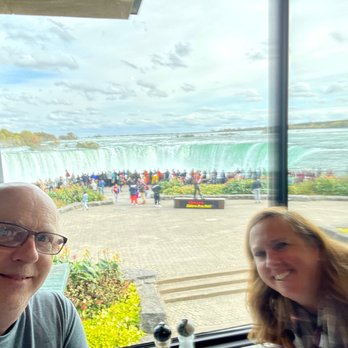 Table Rock House Restaurant - Our smiling happy selves with the beautiful, spectacular and amazing view behind us. - American Near Me - Niagara Falls, Ontario Table Rock House Restaurant - Our smiling happy selves with the beautiful, spectacular and amazing view behind us. - American Near Me - Niagara Falls, Ontario