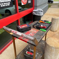 Autozone - Tools and old battery sitting on a cart while Gary replaces the battery in my car.