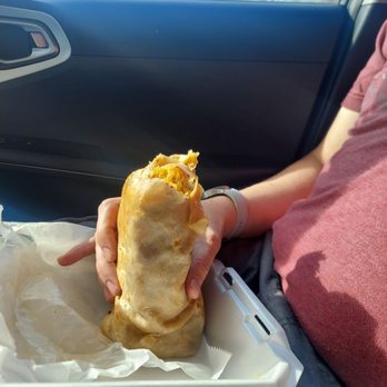 El Taquito Express - a person holding a sandwich - Mexican Near Me - Topeka, Kansas