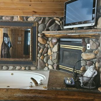 Black Forest Lodge - Spa tub next to gas fireplace and a television above - Hotels Near Me - Big Bear Lake, California Black Forest Lodge - Spa tub next to gas fireplace and a television above - Hotels Near Me - Big Bear Lake, California