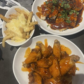 Wings and Rings - Sweet habanero Traditional Wings (Fried) on the bottom, Korean Boneless Wings Grilled, side ofParmesan Side Parmesan Garlic Aioli Fries - Chicken Wings Near Me - Piqua, Ohio