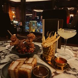 Chicken sando, duck fries, chicken skewers, and a yuzu lemon drop martini.