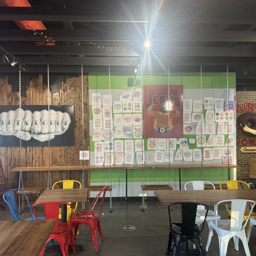 Hurts Donut Company - Inside seating area + cool wall of community art contributions - Donuts Near Me - Omaha, Nebraska Hurts Donut Company - Inside seating area + cool wall of community art contributions - Donuts Near Me - Omaha, Nebraska