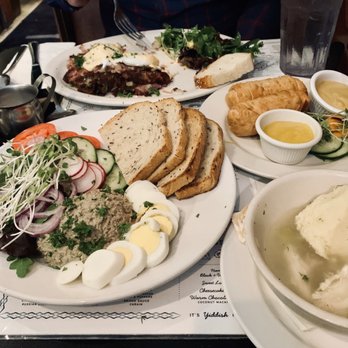 Perly's - Clockwise: Corned beef hash with soft eggs, Jewish egg rolls, matzah ball soup, and chicken liver app. - Delis Near Me - Richmond, Virginia Perly's - Clockwise: Corned beef hash with soft eggs, Jewish egg rolls, matzah ball soup, and chicken liver app. - Delis Near Me - Richmond, Virginia