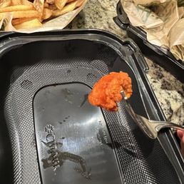 a person holding a spoon full of food