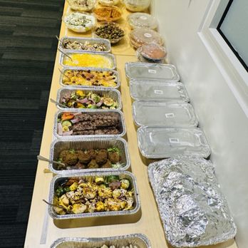 BiBi - a table full of food and containers of food - Mediterranean Near Me - Kirkland, Washington BiBi - a table full of food and containers of food - Mediterranean Near Me - Kirkland, Washington