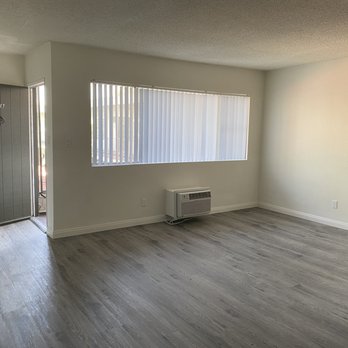 Royal Villa - Open, well lit living room with A/C. - Apartments Near Me - Reseda, California