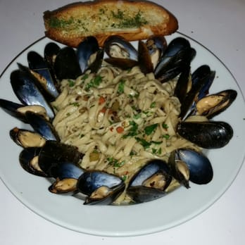 Amici Restaurant Cambridge - a plate of pasta with mussellings and bread - Italian Near Me - Cambridge, Ontario Amici Restaurant Cambridge - a plate of pasta with mussellings and bread - Italian Near Me - Cambridge, Ontario