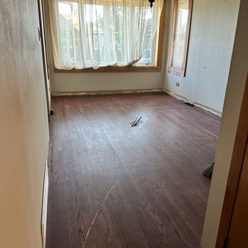 Special Floor - Before picture of living room floor. - Refinishing Services Near Me