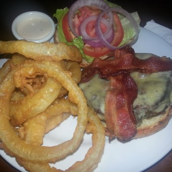 Fire By The Monon - Burger with melted cheddar cheese, onions, tomatoes, lettuce, bacon, avocado, and a horseradish-type sauce & onion rings - American Near Me - Indianapolis, Indiana