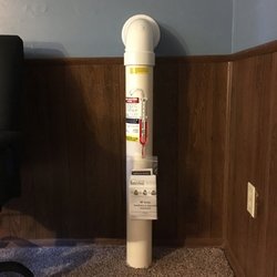 Out Radon - Out Radon installed radon suction pipe in a finished basement with system warranty infos on the pipe.