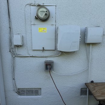 Infinity Electric  - Before, 100 amp panel (between old phone box and fiber optic ONT) - Electricians Near Me - Ventura, California