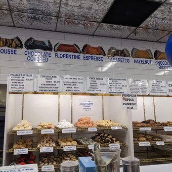 Mike's Pastry - The upper wall has all the cannoli flavors you can buy - Bakeries Near Me - Boston, Massachusetts Mike's Pastry - The upper wall has all the cannoli flavors you can buy - Bakeries Near Me - Boston, Massachusetts
