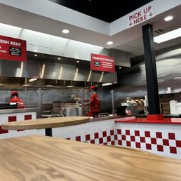 a restaurant kitchen with red and white checkered counter tops