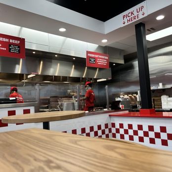 Five Guys - a restaurant kitchen with red and white checkered counter tops - Burgers Near Me - Snellville, Georgia