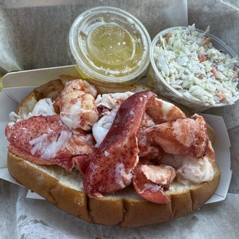 McLoons Lobster Shack - Lobster roll with a side of butter, cole slaw, and a pickle - Seafood Near Me - South Thomaston, Maine