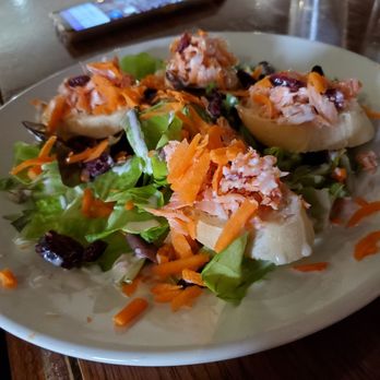 Ray's Wine Spirits Grill - Smoked trout app - A salad featuring stuffed bread pieces, shredded carrots, mixed greens, and dried cranberries, served on a white plate. - Wine Bars Near Me - Dayton, Ohio
