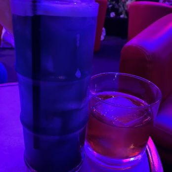 Sacred Palm - a drink and a glass on a table - Speakeasies Near Me - Columbus, Ohio
