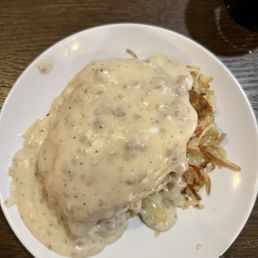 It's a waffle topped with hasbrowns topped with chicken fried steak topped with egg topped with gravy It's a waffle topped with hasbrowns topped with chicken fried steak topped with egg topped with gravy