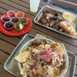 Pitmaster Nachos and Three Meats, Two Sides (brisket, ribs, and chicken with Mac & cheese) Pitmaster Nachos and Three Meats, Two Sides (brisket, ribs, and chicken with Mac & cheese)