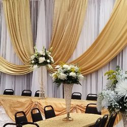 DMG Event Specialist - Gold and white with floral arrangement