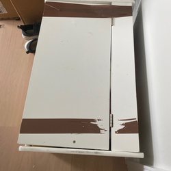 Gigi Moving - Furniture with brown tape.
