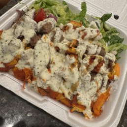 Lamb and chicken over rice with cucumber sauce Lamb and chicken over rice with cucumber sauce