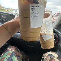 a person holding a cup of iced coffee