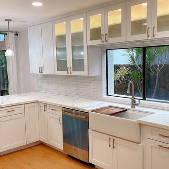 Diamond Head Construction - a kitchen with white cabinets and stainless steel appliances - General Contractors Near Me - Honolulu, Hawaii