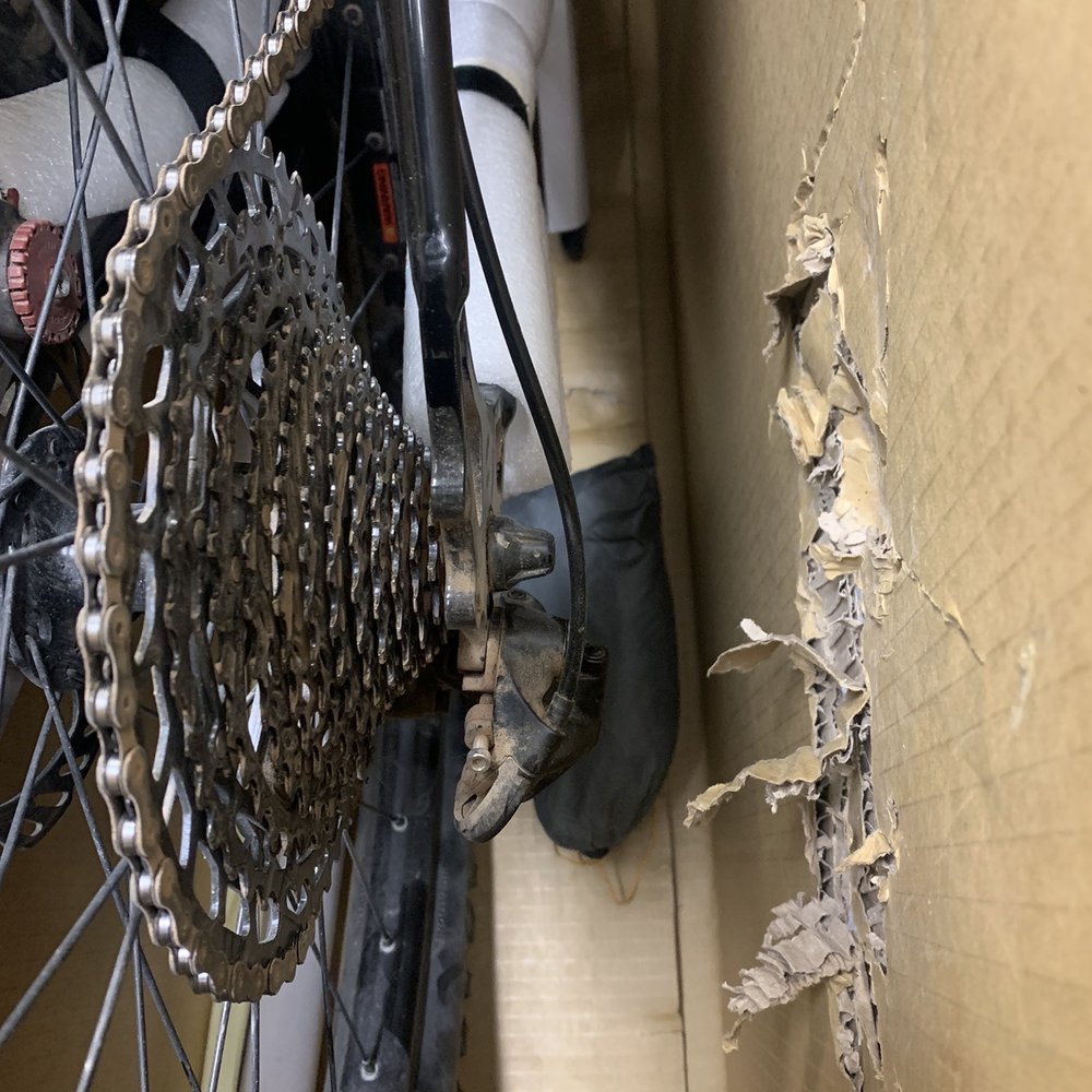 Nice, zero protection for my derailleur or rear dropouts! Note the shredded cardboard from the derailleur and rear QR. Nice, zero protection for my derailleur or rear dropouts! Note the shredded cardboard from the derailleur and rear QR.
