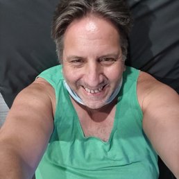 a man in a green shirt with a collar around his neck a man in a green shirt with a collar around his neck