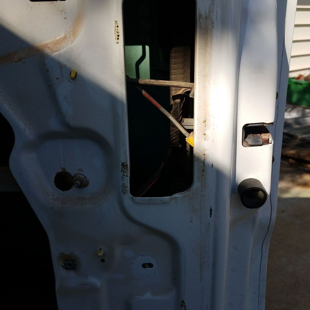 The missing screw holds the glass guide track to the door