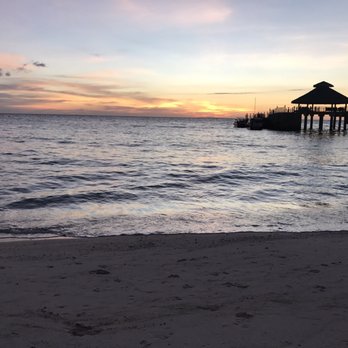 Shangri-La's Boracay Resort and Spa - Their main private beach with the arrival/departure dock lit by the sunset - Resorts Near Me - Malay, AKL